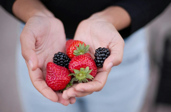 three strawberries and two blackberries